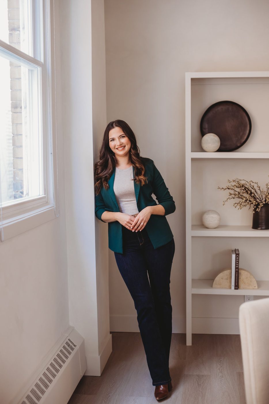 Maggie McTavish, founder of Mango Media and speaker on AI search, in a pine-green blazer