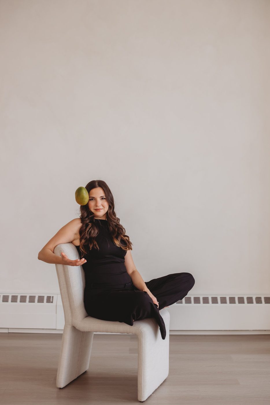 Maggie McTavish balancing a green mango — a nod to her Panamanian roots and the name Mango Media